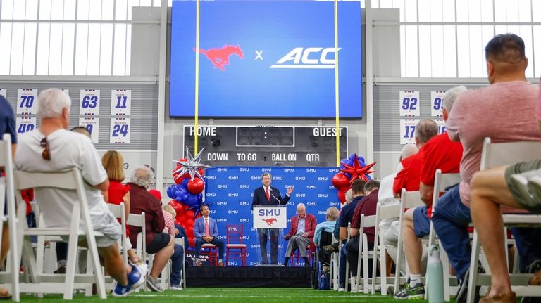 SMU president R. Gerald Turner, center, speaks during a news...