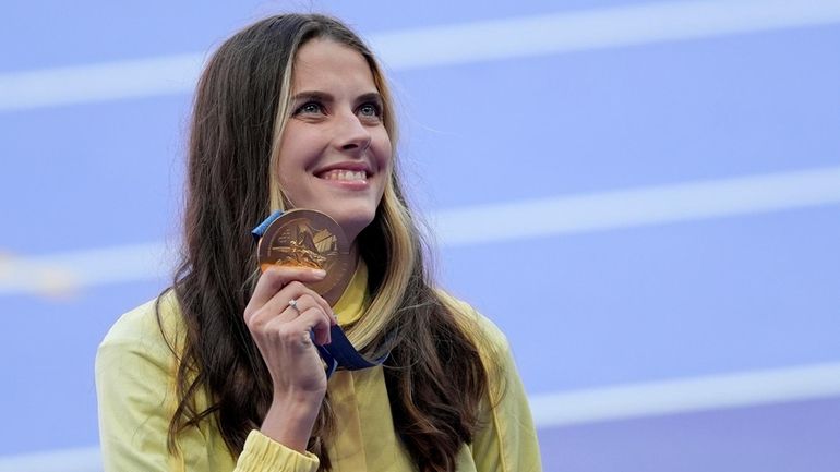 Women's high jump gold medalist Yaroslava Mahuchikh, of Ukraine, poses...