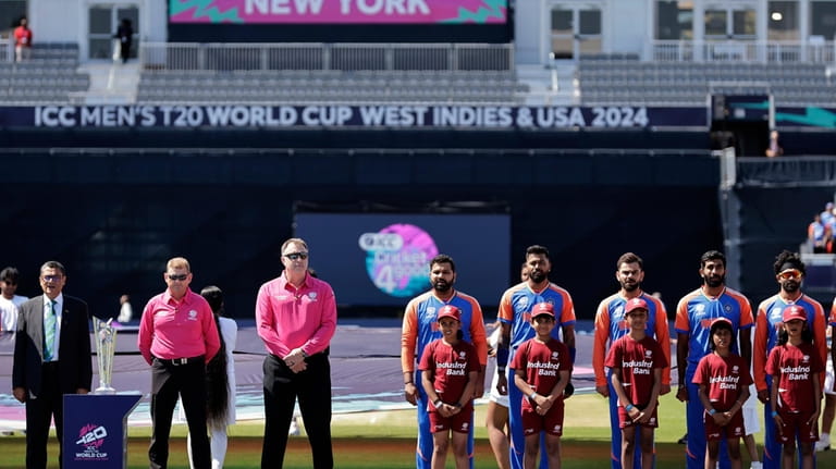 Players of team India stand for their national anthem before...