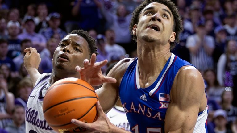 Kansas' Kevin McCullar Jr., right, has the ball stripped away...