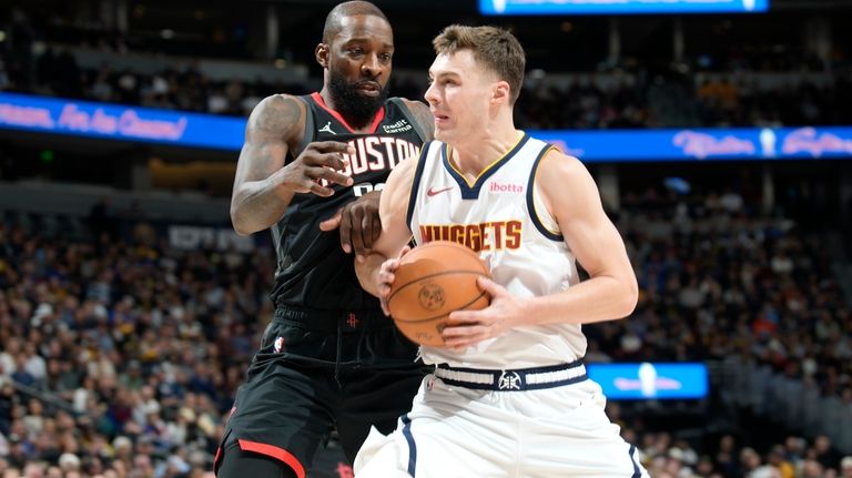 Denver Nuggets guard Christian Braun, right, works against Houston Rockets...