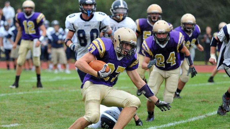 Sayville Golden Flashes running back John Haggart (27) runs with...