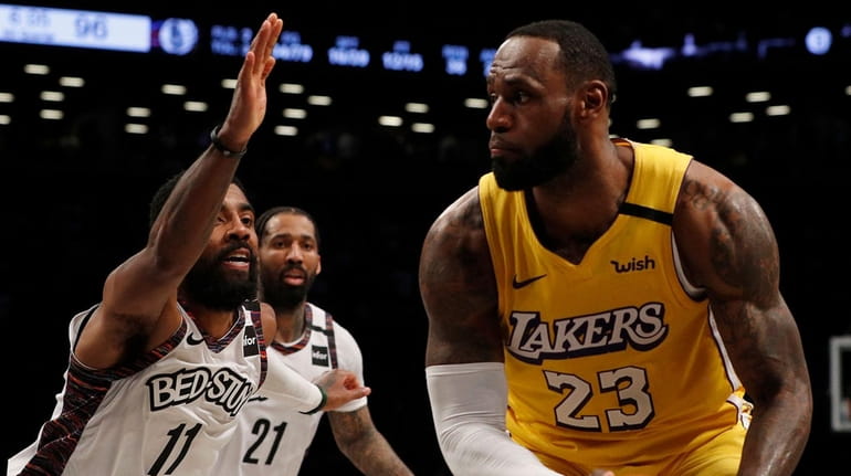 LeBron James of the Los Angeles Lakers controls the ball during...