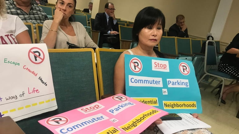 May Affatato, of Syosset, holds a sign protesting parking on...
