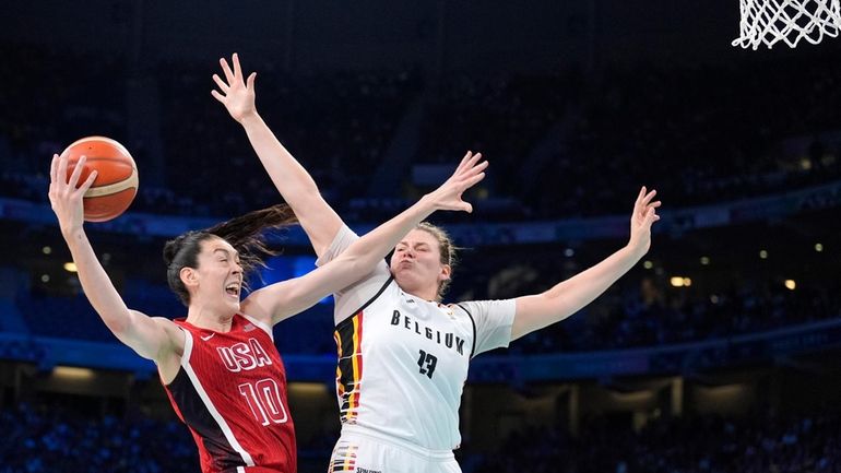 United States' Breanna Stewart, left, shoots as Belgium's Kyara Linskens...