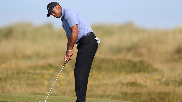 Tiger Woods of the United States puts on the 10th...