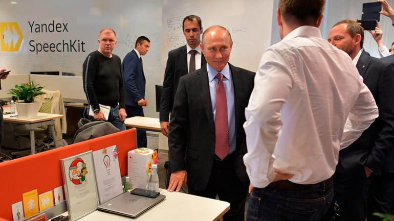 Russian President Vladimir Putin, center, visits Russia's largest internet search...