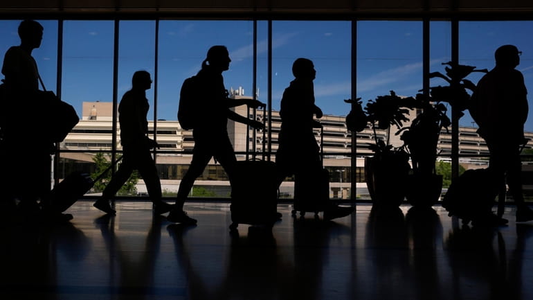 Travelers walk through the Philadelphia International Airport, Wednesday, July 3,...