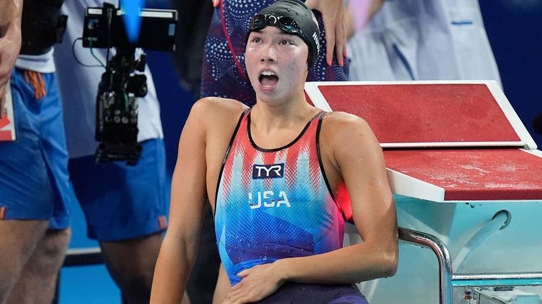 United States' Torri Huske celebrates winning the last lap in...