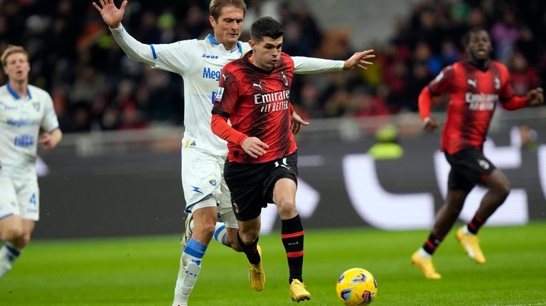 AC Milan's Christian Pulisic runs with the ball to score...