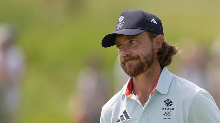 Tommy Fleetwood, of Britain, reacts after playing his tee shot...