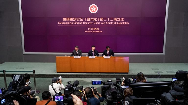 Hong Kong Chief Executive John Lee, center, Secretary for Justice...