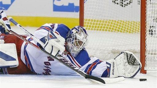 Rangers goalie Henrik Lundqvist stops a shot on goal against...