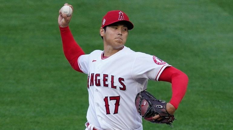 Angels starting pitcher Shohei Ohtani throws during the first inning of...