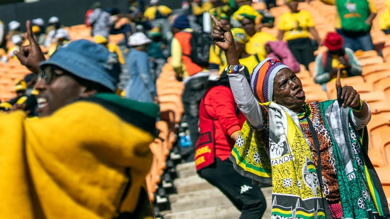 African National Congress supporters wait for South African President Cyril...