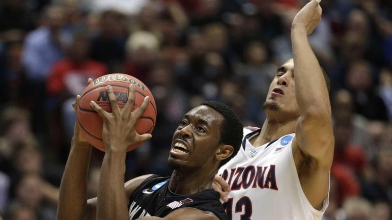 San Diego State guard Xavier Thames, left, drives past Arizona...