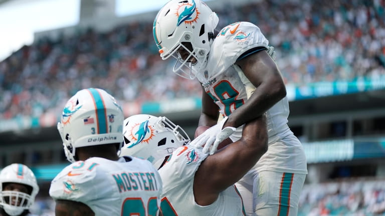 Miami Dolphins defensive tackle Christian Wilkins (94) lifts running back...