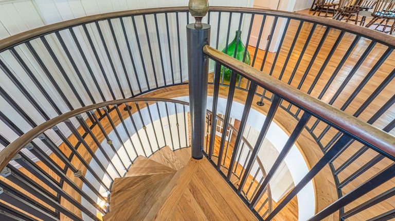 A spiral staircase leads to the second floor.