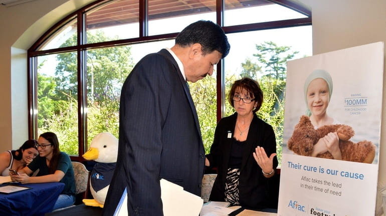 Loraine Sommer, a district sales coordinator for Aflac, speaks with...