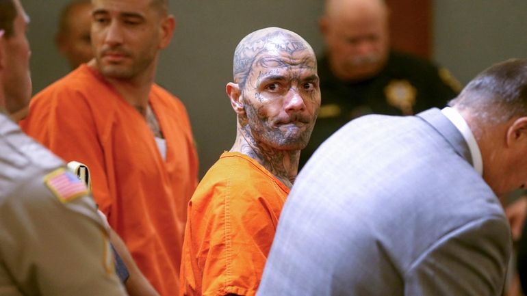 Anthony Williams, center, and Tarik Goicoechea, left, appear in court...