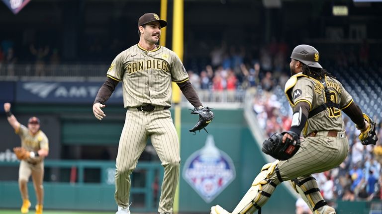 San Diego Padres starting pitcher Dylan Cease, center, celebrates his...