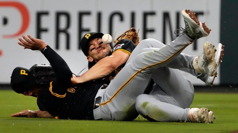 Pittsburgh Pirates second baseman Nick Gonzales, left, and right fielder...