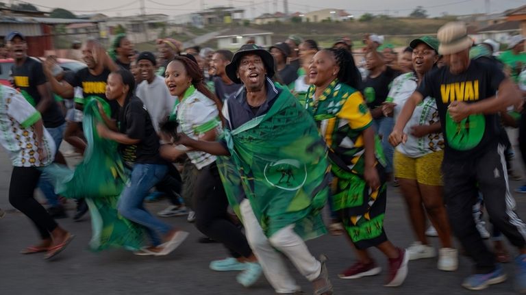 MK Party supporters celebrate in the middle of the street...