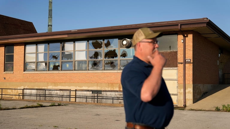 West Alton Mayor Willie Richter speaks outside a vacant and...
