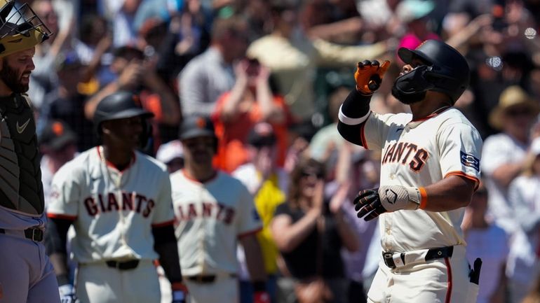 San Francisco Giants' Heliot Ramos, right, celebrates next to Colorado...