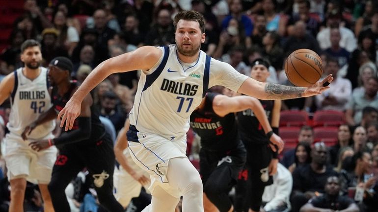 Dallas Mavericks guard Luka Doncic (77) grabs a loose ball...