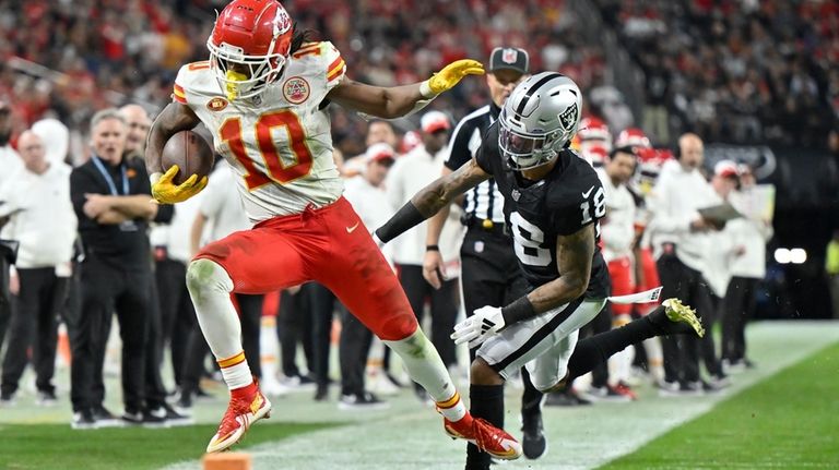 Kansas City Chiefs running back Isiah Pacheco (10) is pushed...