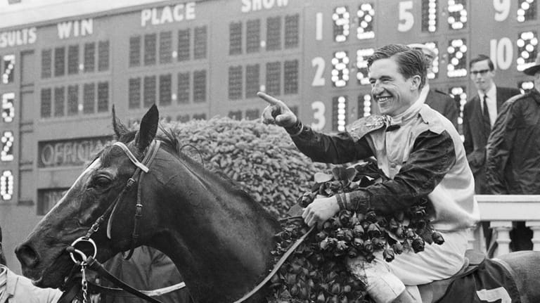 Jockey Bob Ussery sits atop Proud Clarion as they entered...