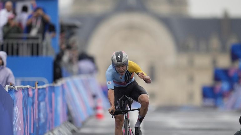 Remco Evenepoel, of Belgium, wins the men's cycling time trial...