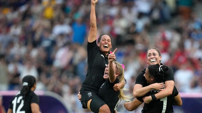 New Zealand team member celebrate after winning the women's gold...