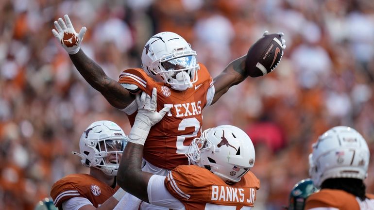 Texas wide receiver Matthew Golden (2) celebrates with teammates after...