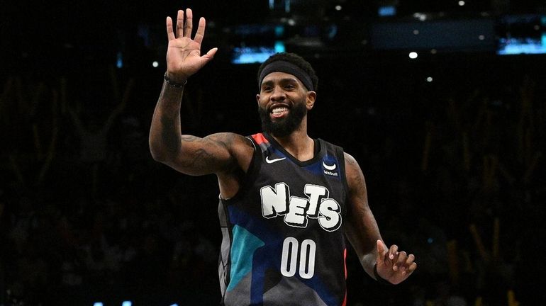 Nets forward Royce O'Neale reacts after sinking a three-point basket...