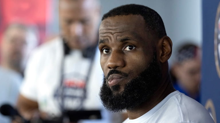 LeBron James of the Los Angeles Lakers listens to a...