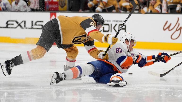 Golden Knights right wing Mark Stone knocks Islanders left wing Anders Lee to...