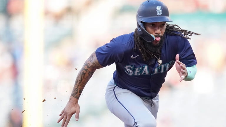 Seattle Mariners' J.P. Crawford runs to third base during the...