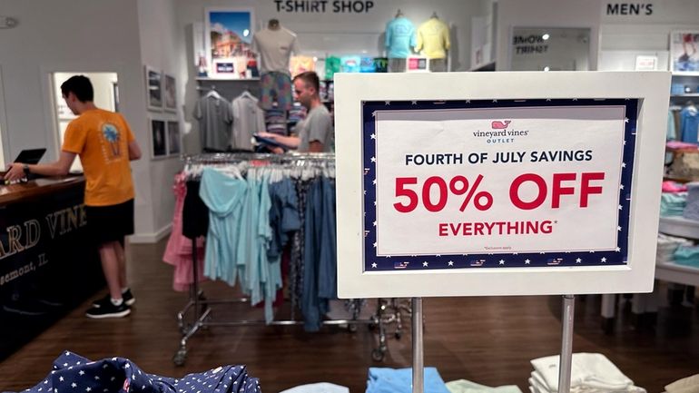 A holiday sale sign is displayed at a retail store...