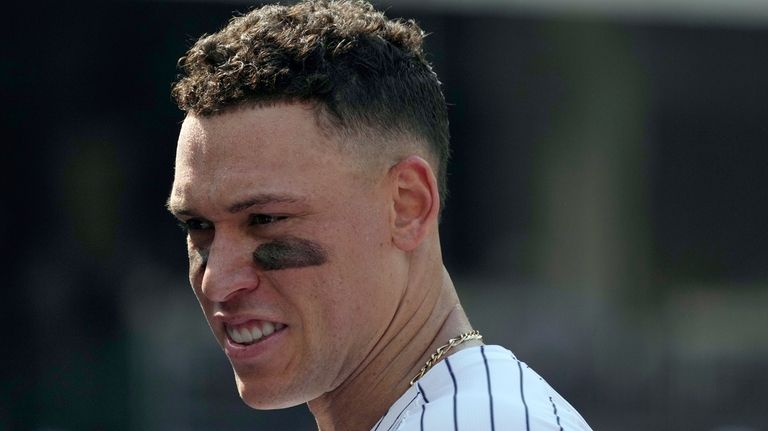 New York Yankees' Aaron Judge stands in the dugout during...