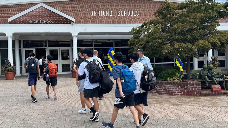 Students arrive at Jericho High School for the first day...