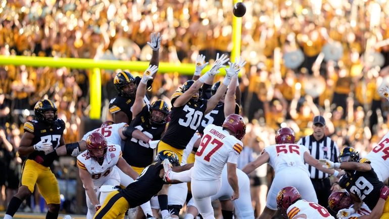 Iowa State place kicker Kyle Konrardy (97) kicks a 54-yard...