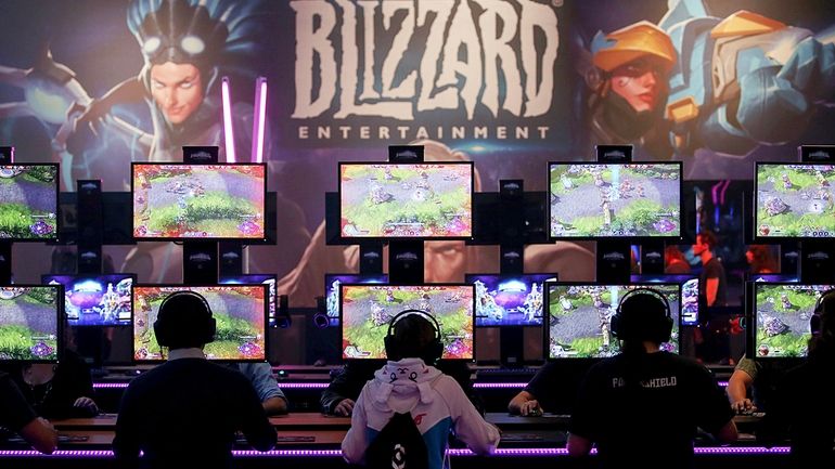 Gamers test out computer games at the Gamescom in Cologne,...