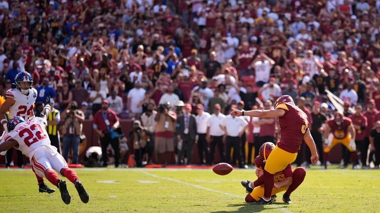 Washington Commanders place kicker Austin Seibert (3) kicks the game-winning...