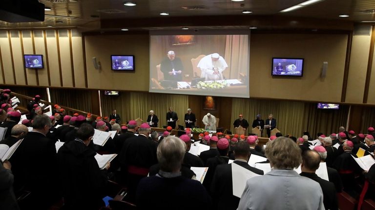 Pope Francis prays at the beginning of the third day...