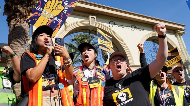 SAG-AFTRA captains Iris Liu, left, and Miki Yamashita, center, and...