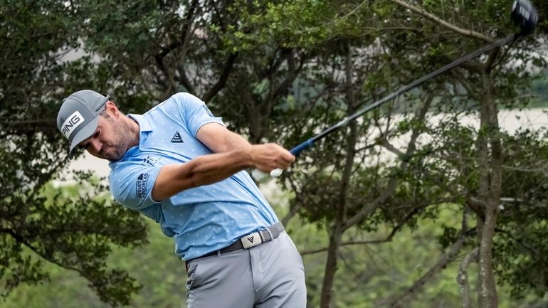 Corey Conners tees off on the 18th hole during the...