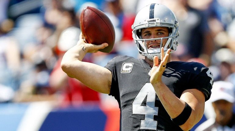 Quarterback Derek Carr of the Raiders passes the ball against...