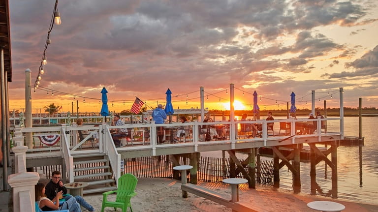 Outdoor dining at sunset at Buoy Bar in Point Lookout.